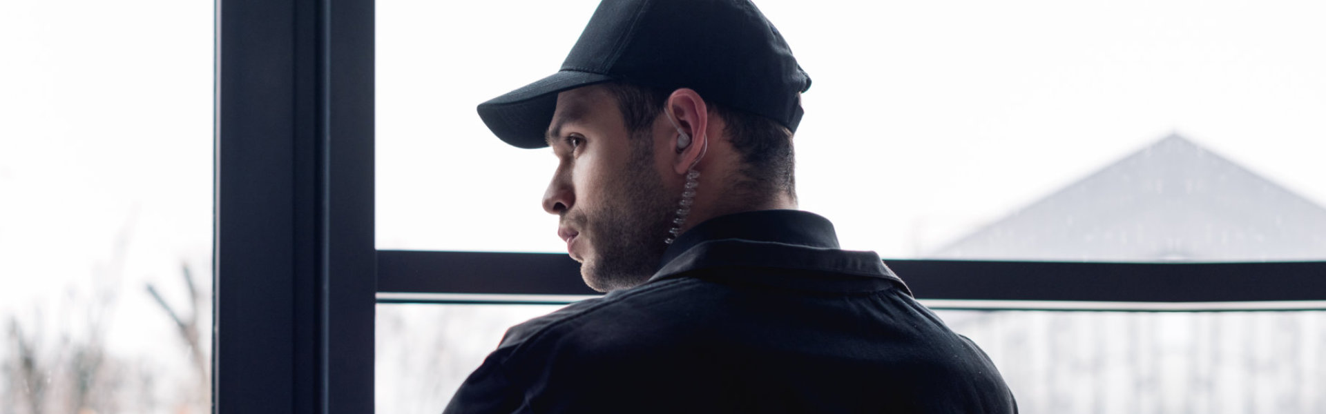 A male security personnel wearing a cap