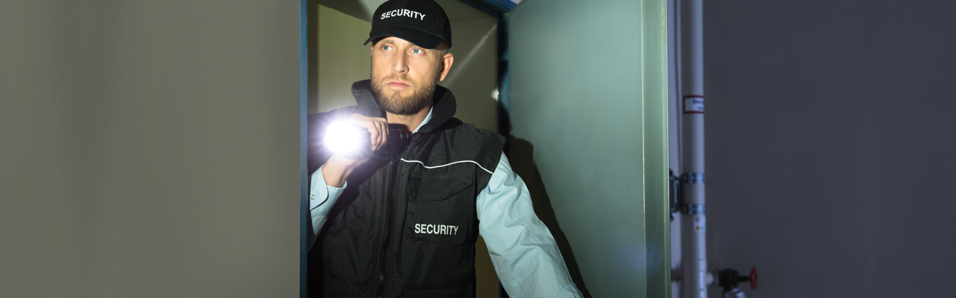 male security searching with a flashlight